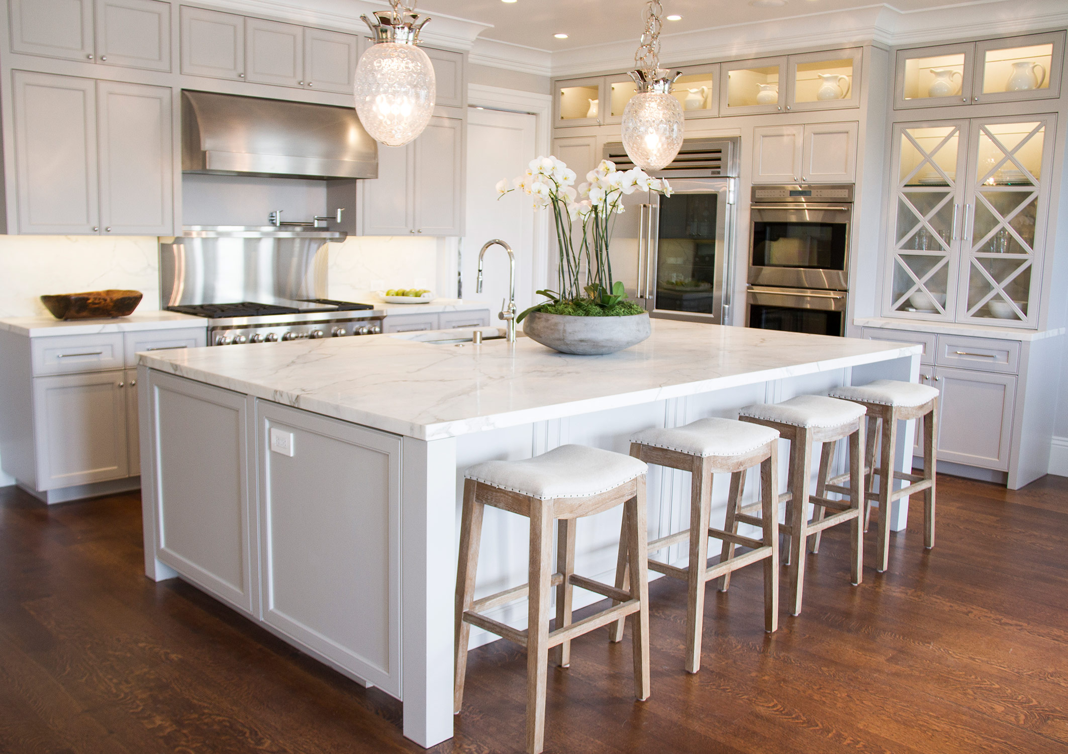 kitchen, simple, white, marble countertop, barstools, cabinets, glass cabinets, stainless steel, appliances, open layout, 