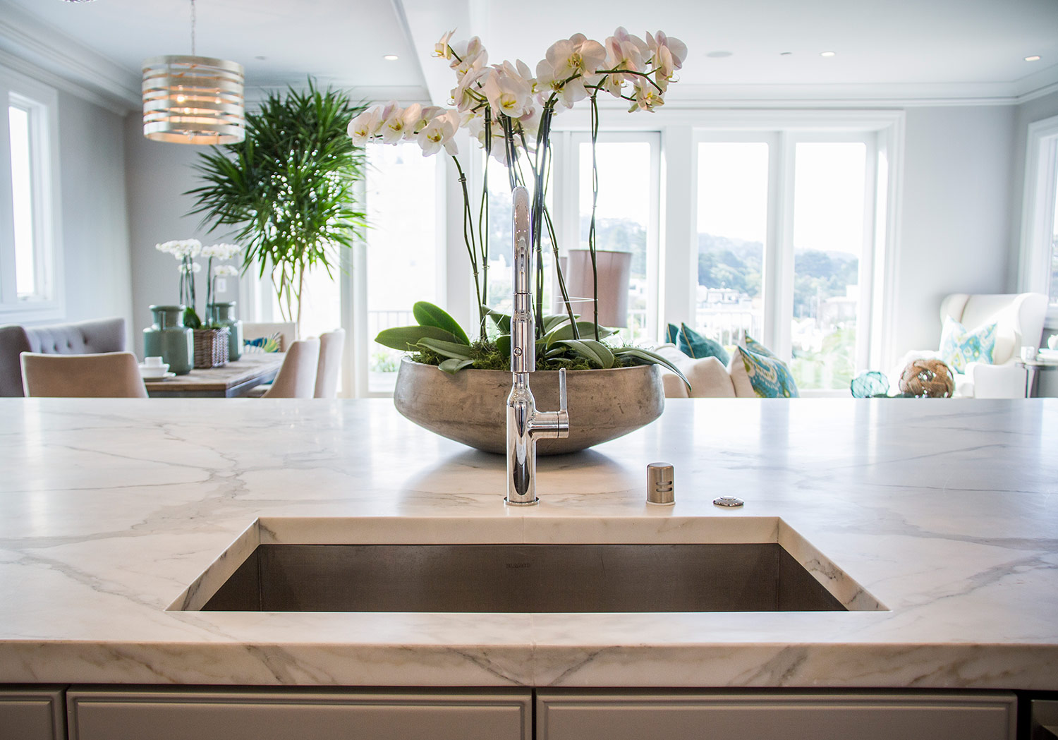 kitchen, marble counters, open space, dining room, detail, chandelier, lighting, open layout, overhead lighting, sink, faucet 
