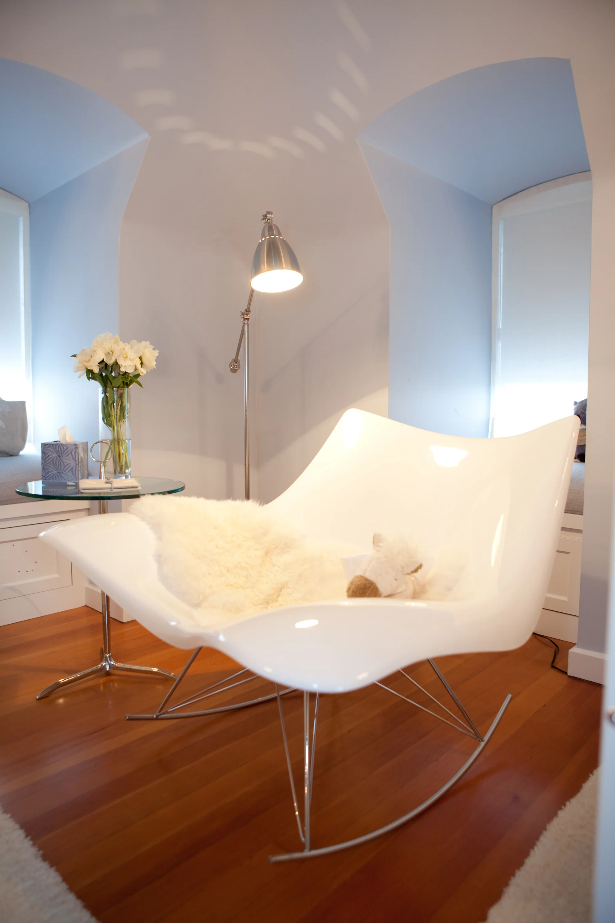 nursery, white, hardwood floor, sitting area, nursing chair, fur, lighting 