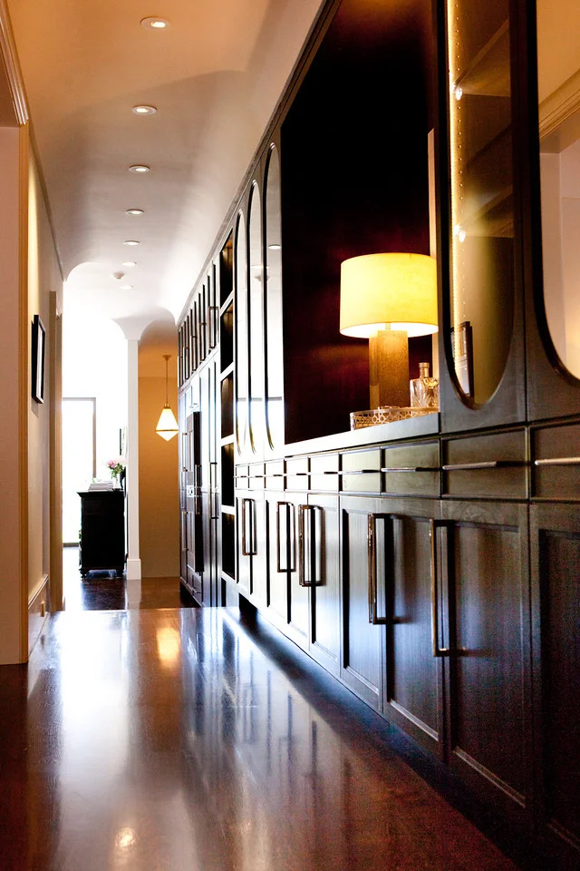 traditional cabinetry, warm tones, hardwood floor, book shelf, library, storage