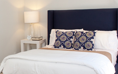 modern bedroom, bed, throw pillows, bedside table, bedside lamp