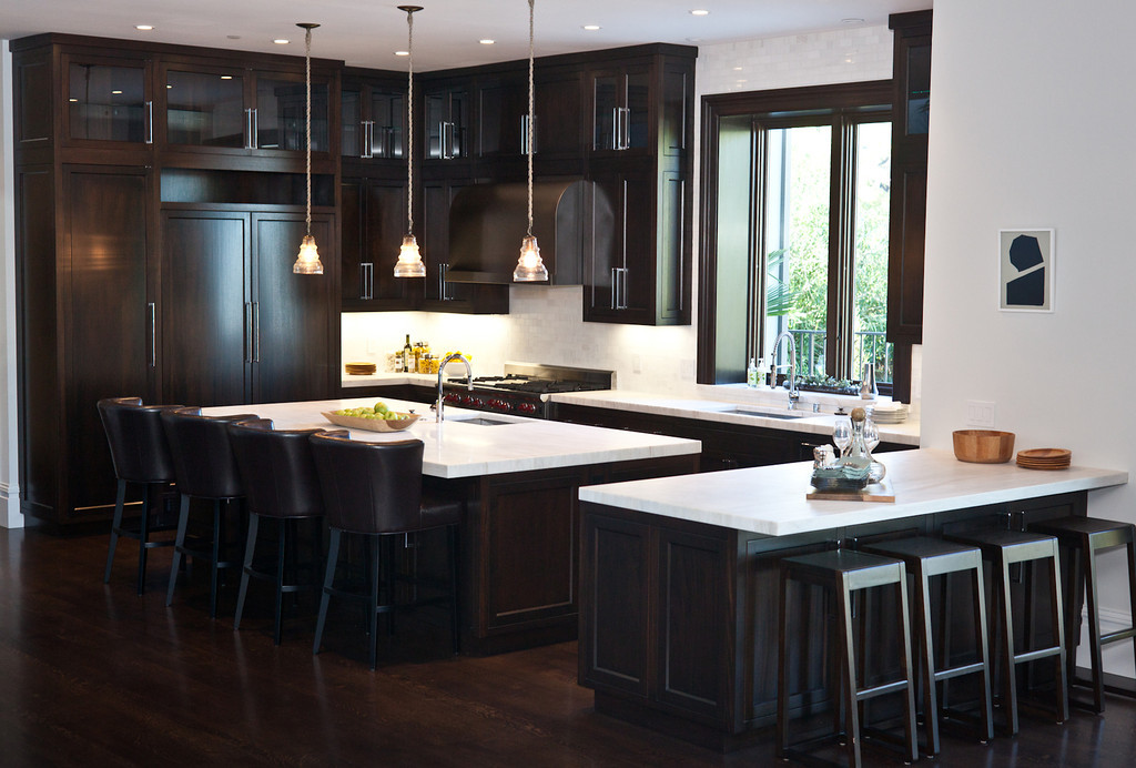 Kitchen, marble counters, barstools, counter stools, kitchen cabinetry, hardwood floors, dark stain