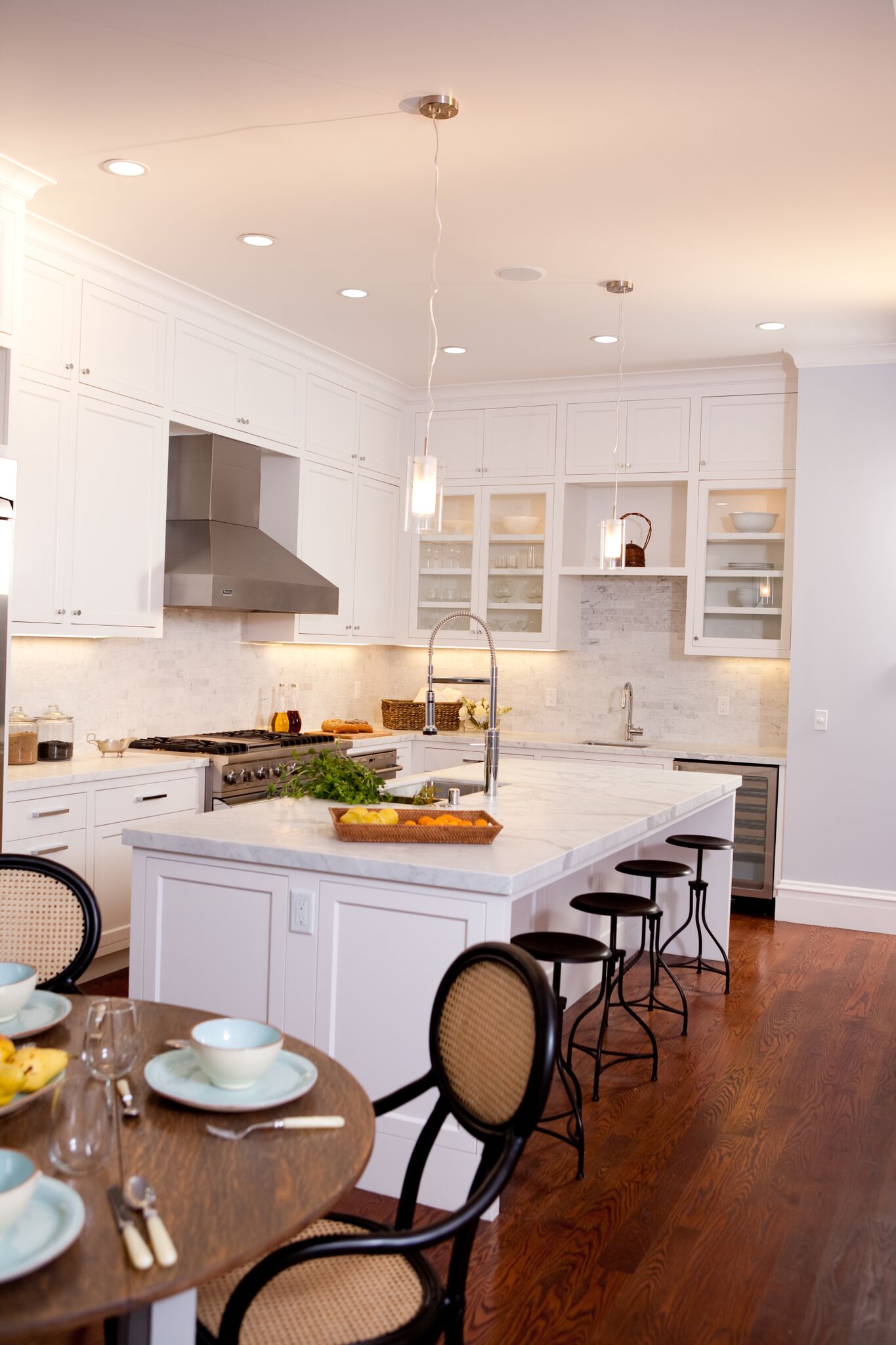 kitchen, bar stools, breakfast nook, stainless steel appliances, carerra marble counters, subway tile backsplash