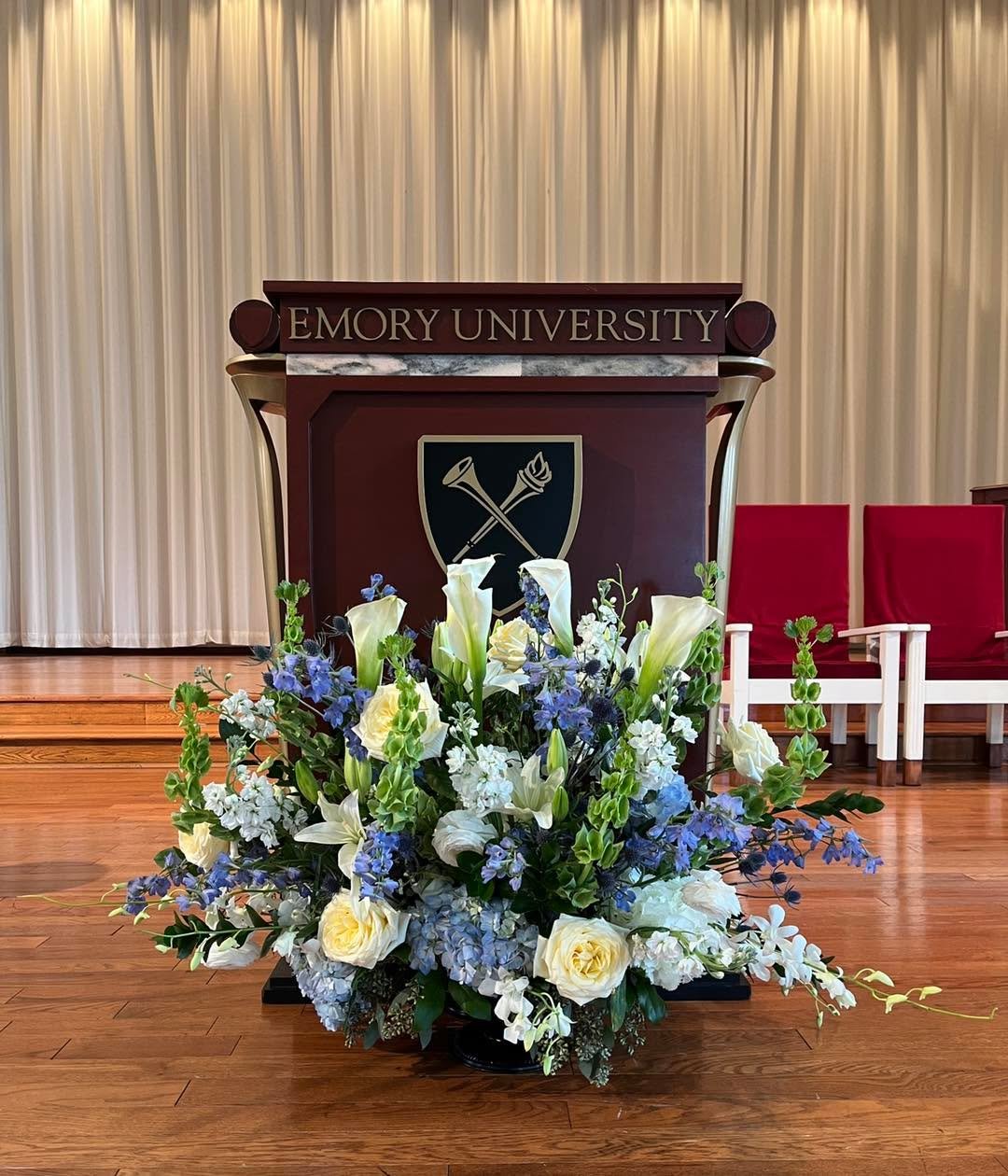 For when the setting matters as much as the words.
This podium piece was created for Emory University&mdash;designed to feel grounded, intentional, and worthy of the moment. We believe florals should support the message, not compete with it.

Refined