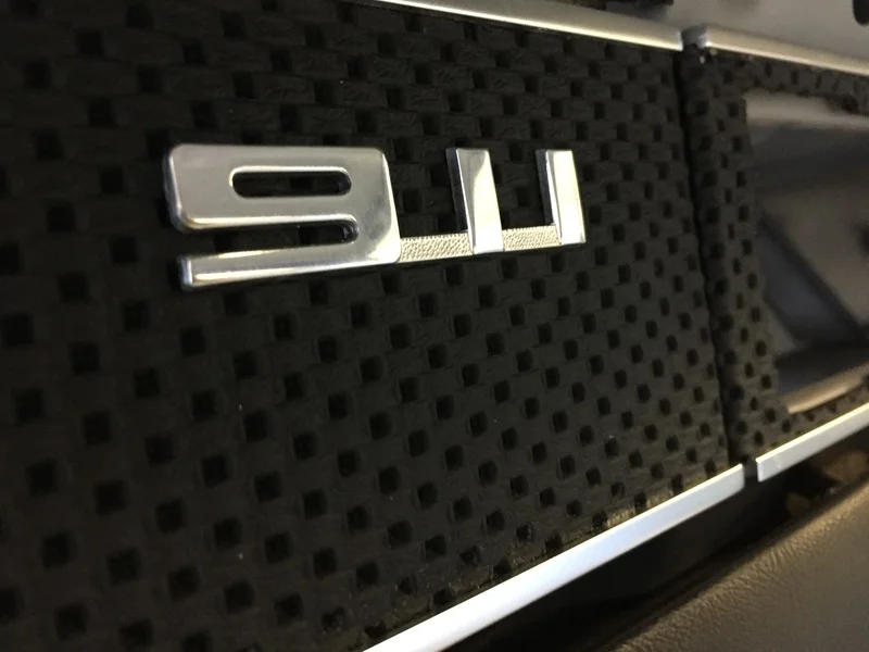 The last finishing touch which has the drill holes already in the glove box panel is the 911 badge. 
