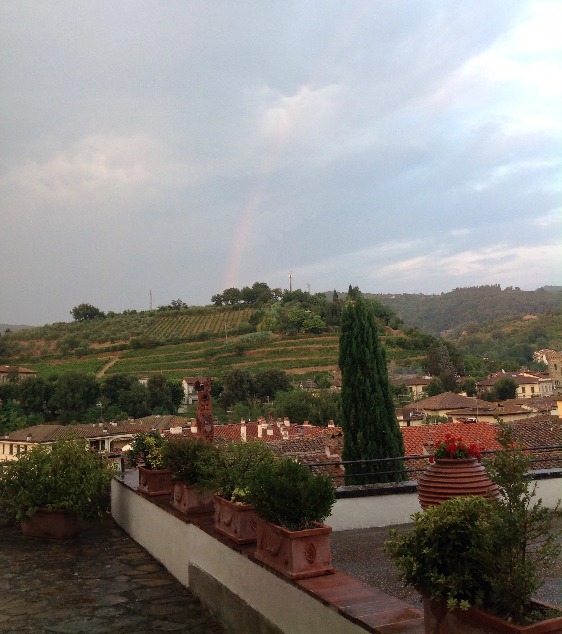 A rainbow forms over the Tuscan hills - a view from the group's villa.