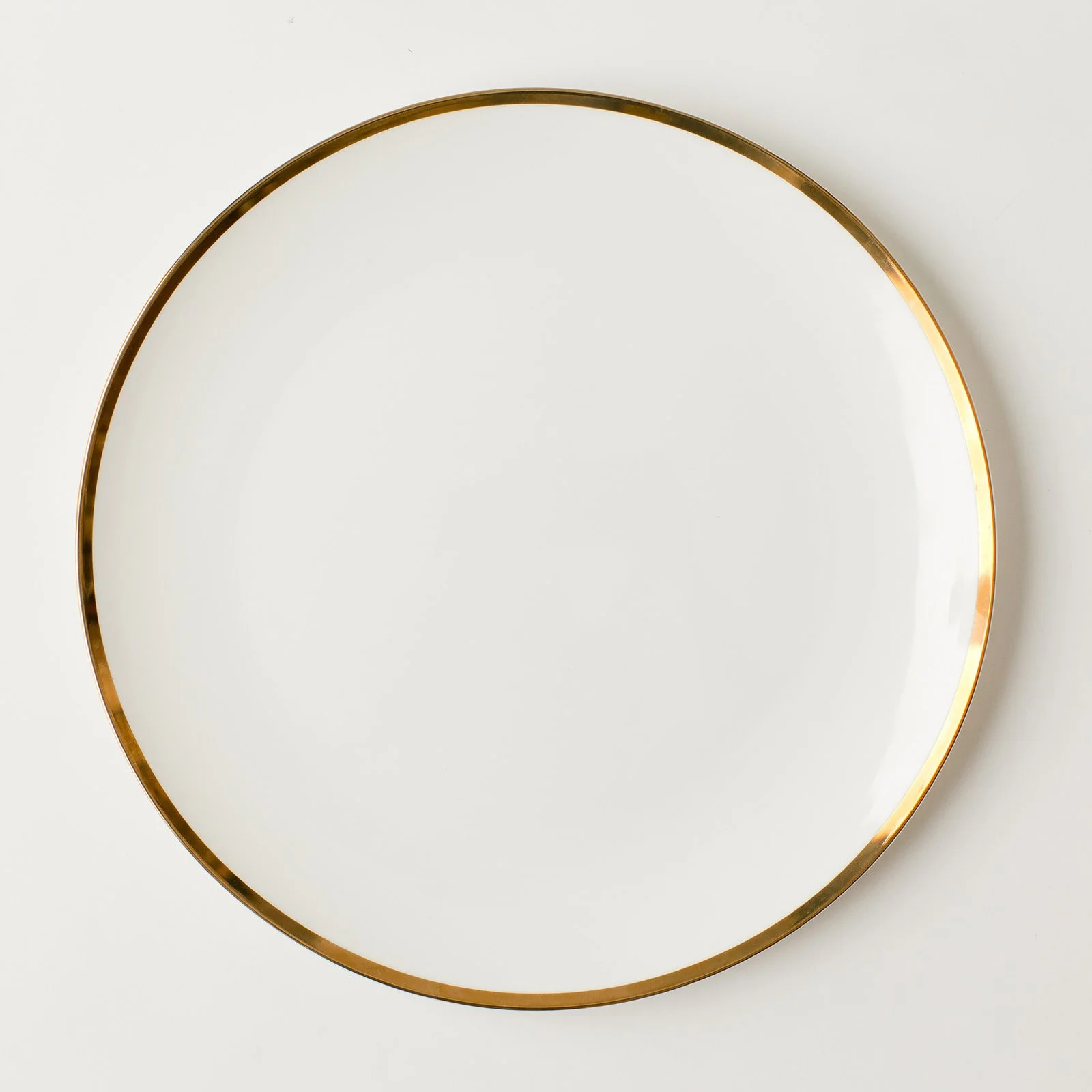 coupe shaped plate with thin gold band.jpeg