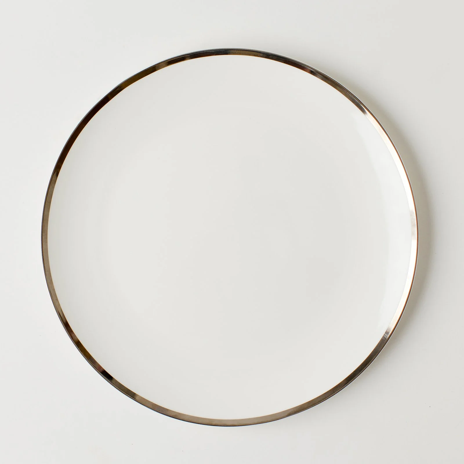 coupe shaped plate with thin silver band.jpeg