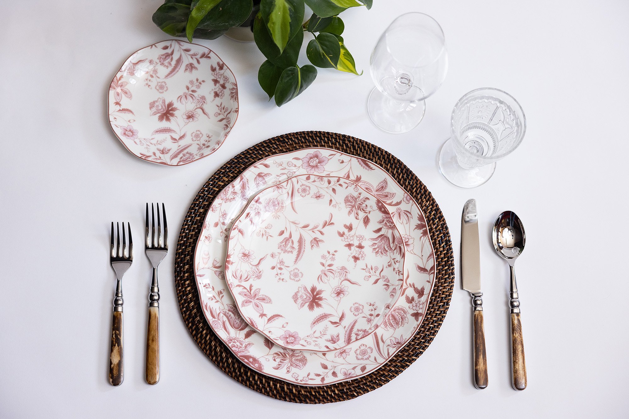 red-floral-plate-with-rattan-charger-and-wood-silverware-event-table-rental-chicago.jpg