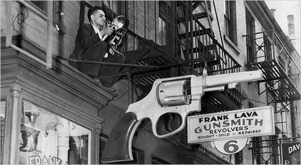 Copy of Weegee perched on a fire escape, New York. Photo by Leigh Wiener.