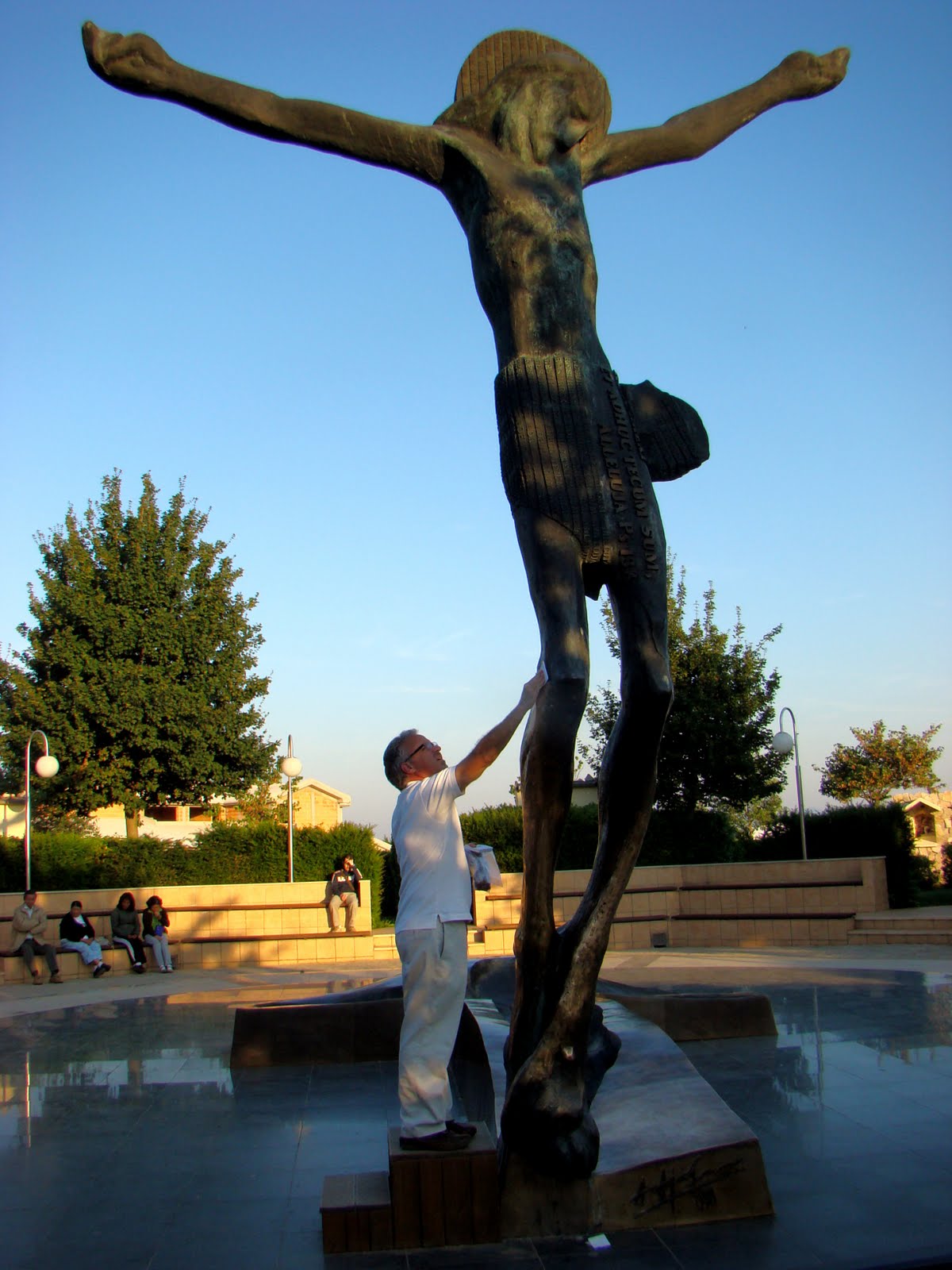 Collecting fluid from the "weeping knee" of the Risen Christ statue, Medugorje, Hercegovina