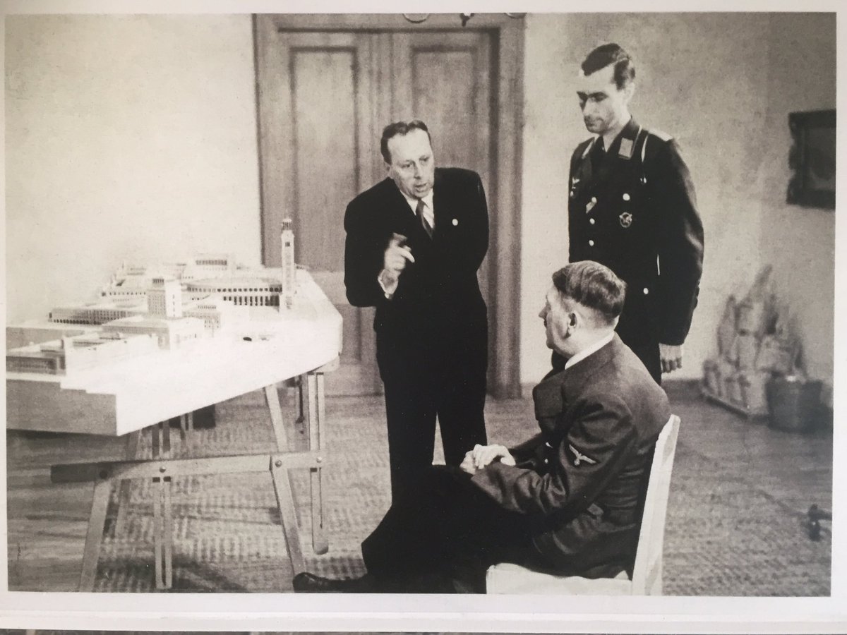  Hitler (seated) admires the plans for Linz alongside his architect,&nbsp;Herman Gisler (left) 