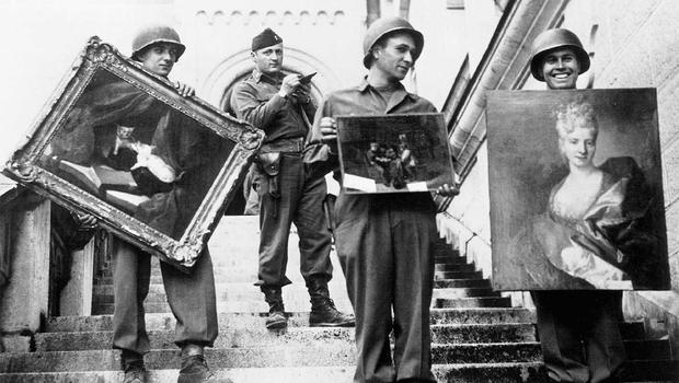 American GIs, under the supervision of Capt. James Rorimer, carry paintings down the steps of Neuschwanstein Castle in southern Germany. Courtesy National Archives and Records Administration