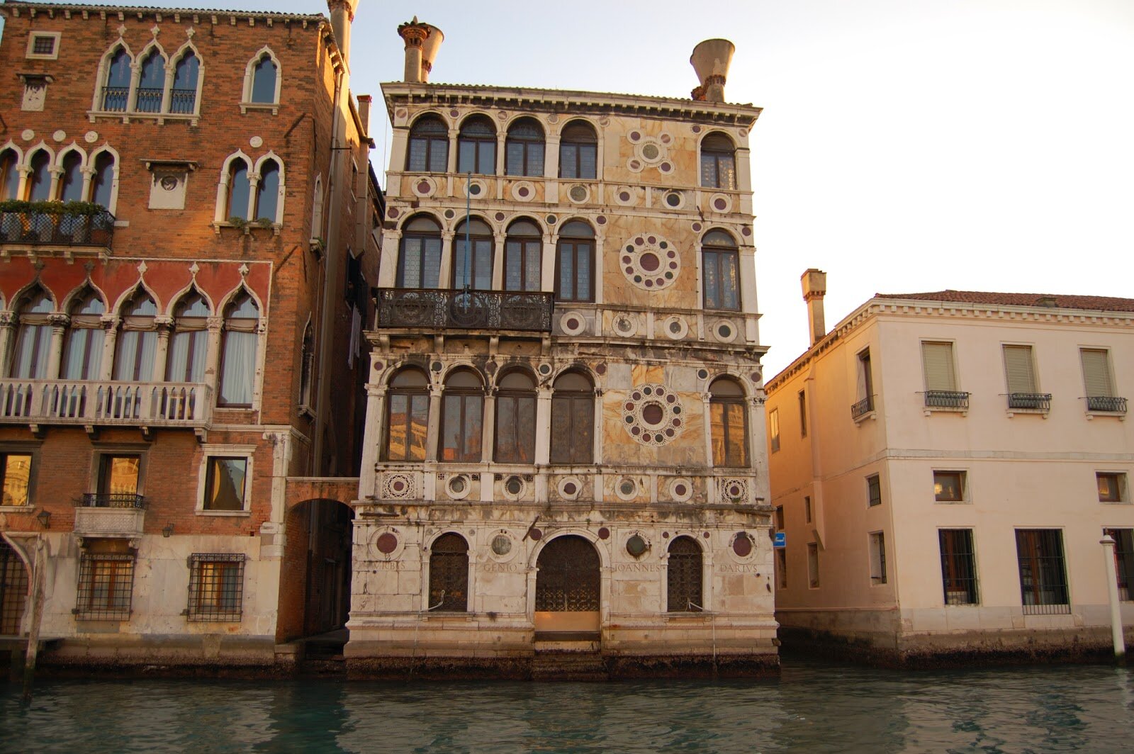 ornate building with arched windows on water