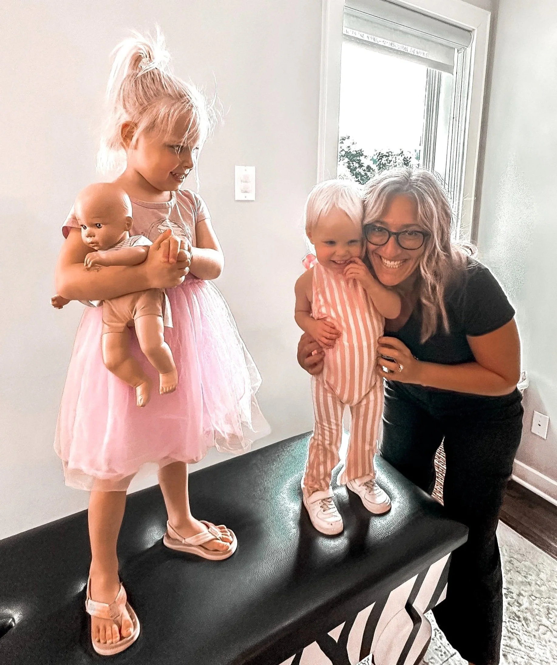 Woman with two kids indoors