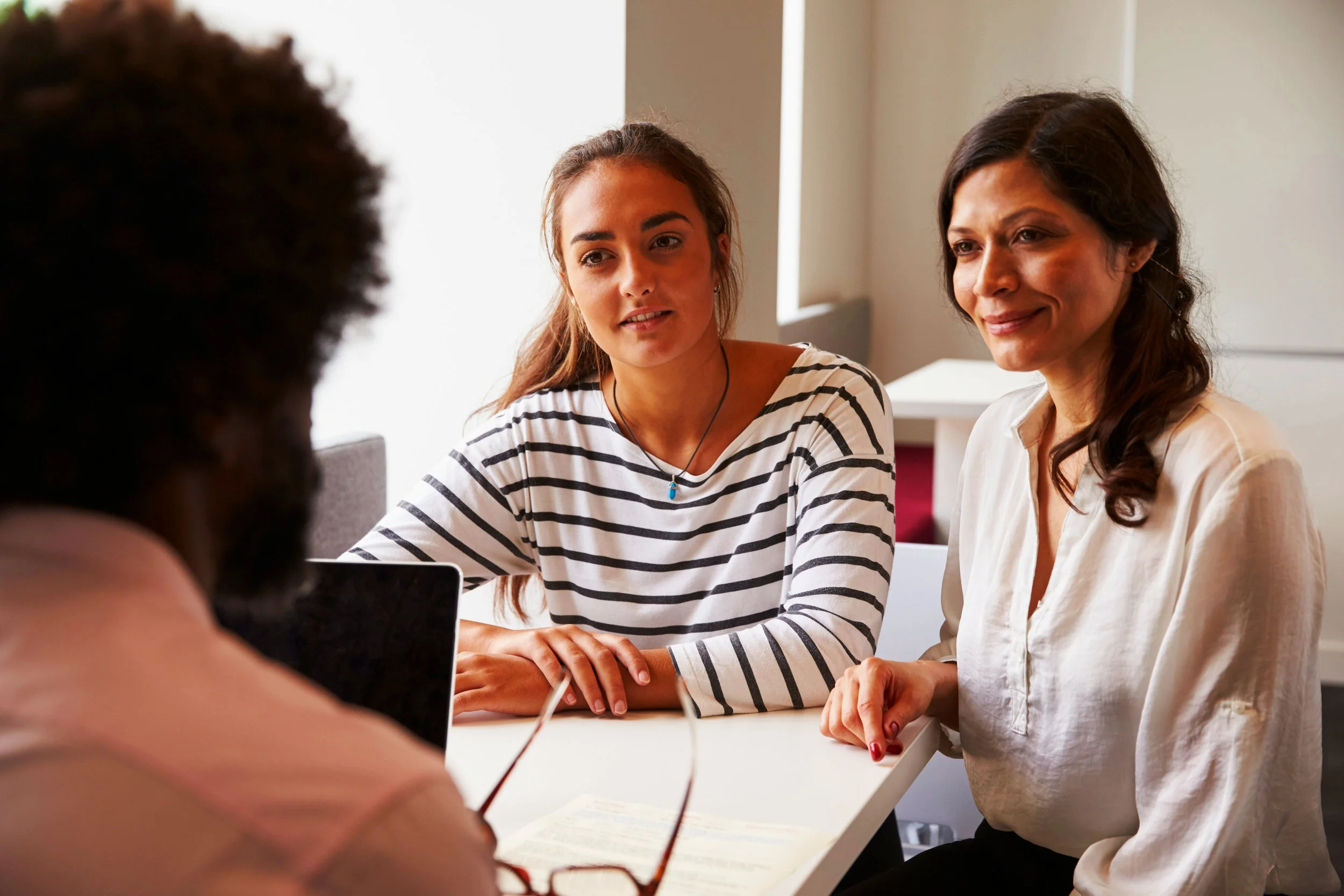 People+sitting+at+a+table+-+two+young+women.jpg