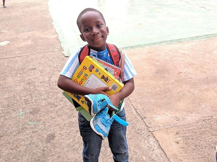 In year 2 of the RozaayMGMT Book &amp; Sneaker Drive Randy Osei and team collected over 550 sneakers and raised $12,000 dollars. (Photo by: RozaayMGMT)