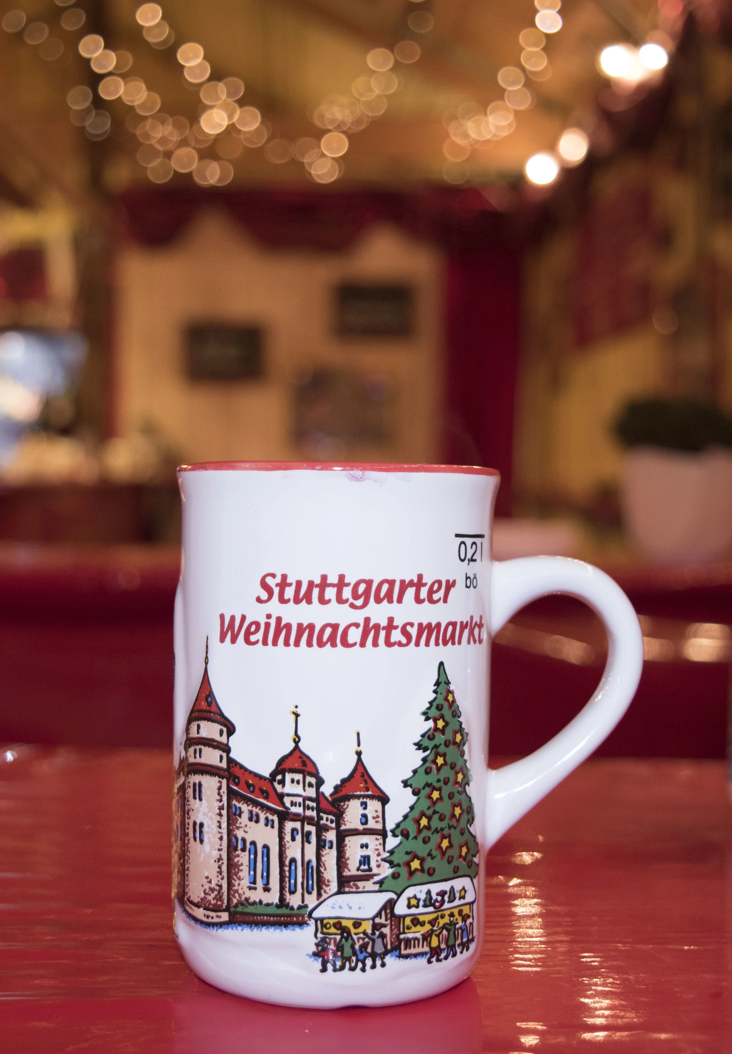 Attendees are often found drinking glühwein (mulled wine) at the Christmas Market in Stuttgart, Germany. Return the mug to the vendor if you wish to receive your deposit back, or keep it as a souvenir.