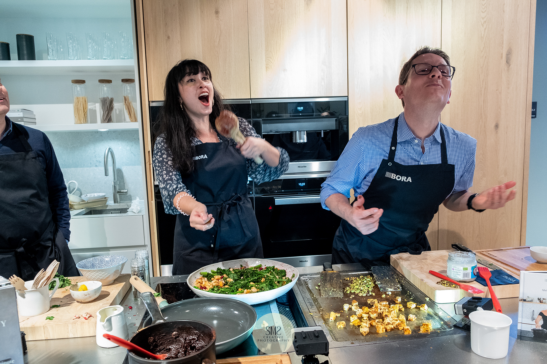 'Espresso Design' Melissa Hemsley demonstating Bora kitchen appliances and how to throw a cube of hallumi and for your co-host to catch it in his mouth
