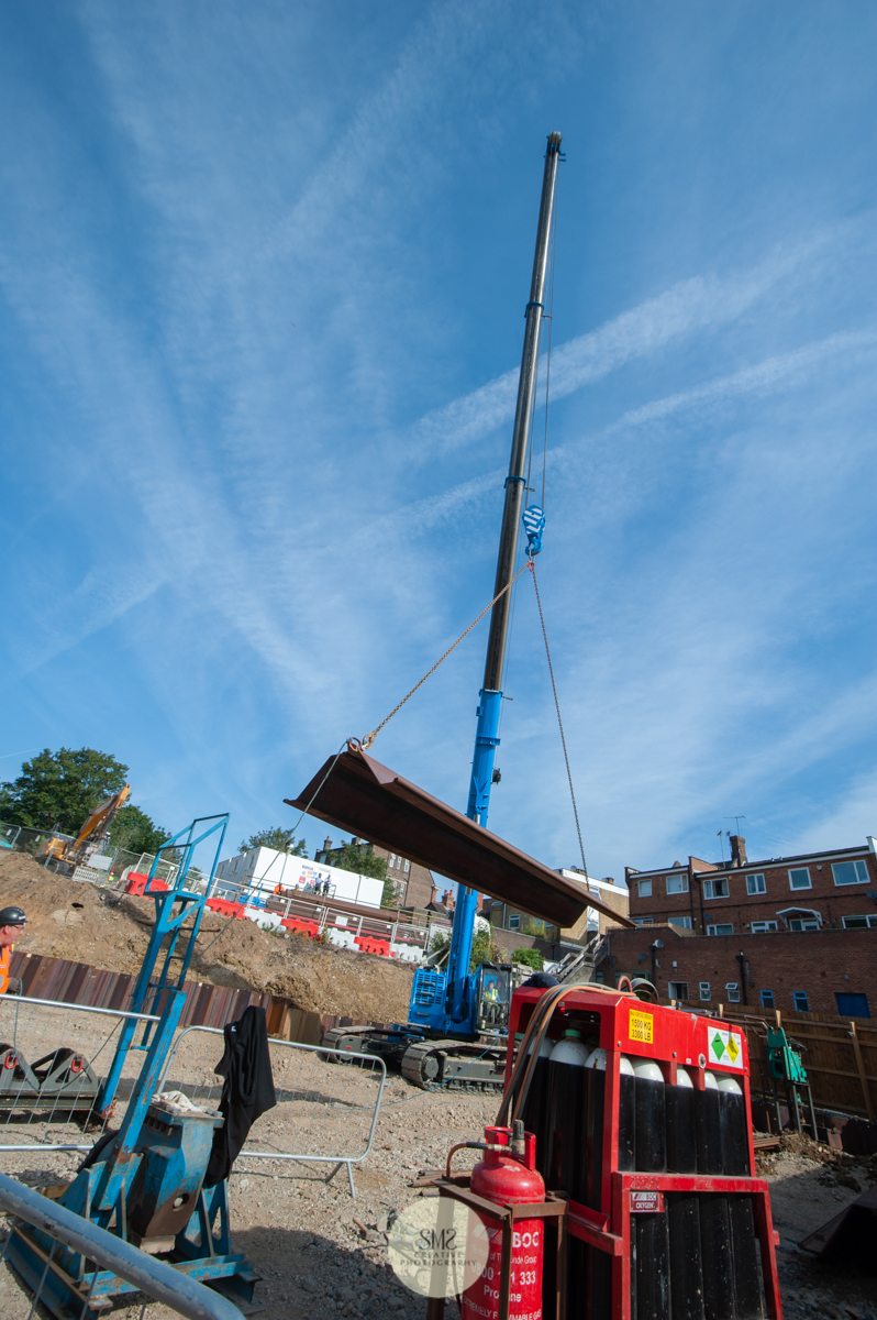  A view of the crane unloading the sheet piling from the delivery lorry on site 