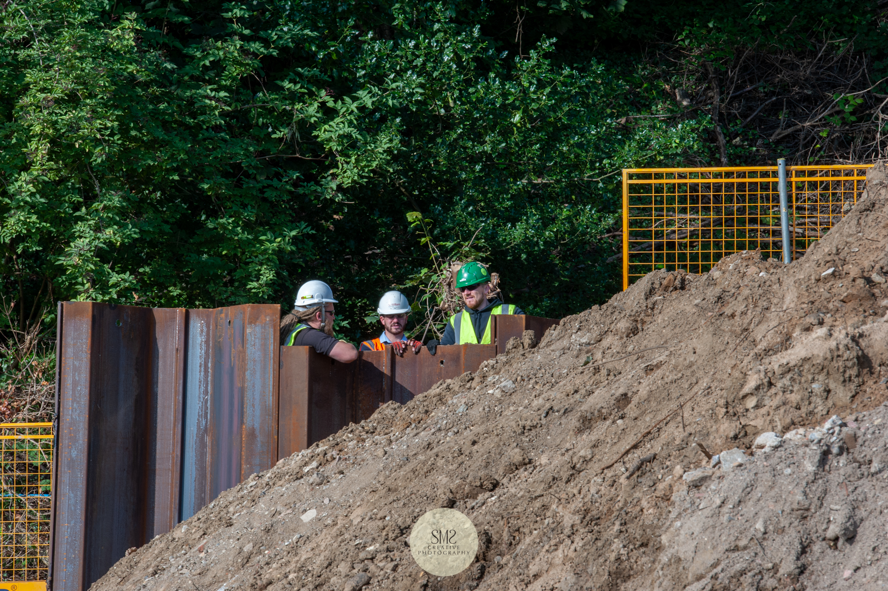  This shows you how high some of the sheet piling is as engineers tower over and discuss the progress. 