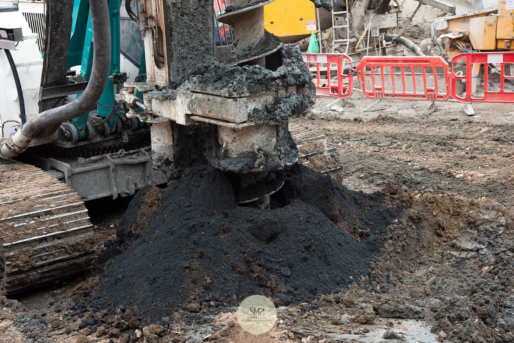 The drill of the auger takes away the earth in preparation for the cement to be filled in the cavity.
