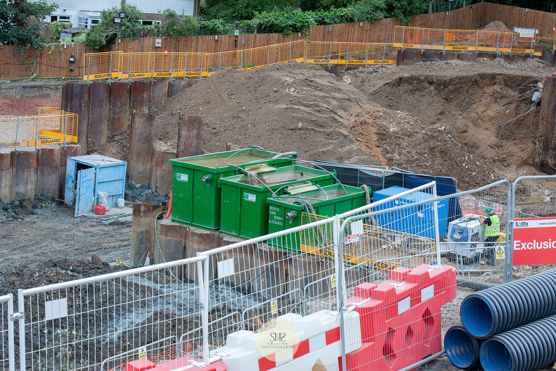  The three water tanks process the excess rainwater that is collected at the base of the site to a filtration and purifying system via a hose. You can see the sheet piling in this picture too. 