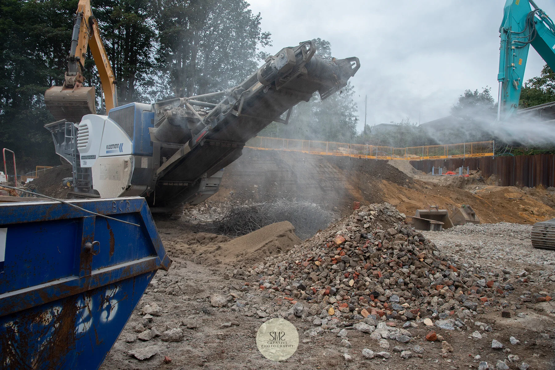 The crusher has separated the hardcore into 3 piles - scrap metal, crushed hardcore and settled dust from the crushed hardcore.