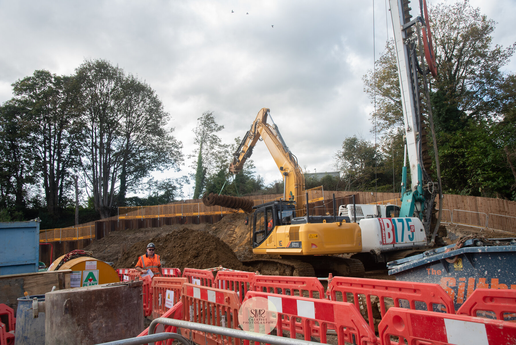  A view of the two machines that work together during the drilling process on the piling mat. The piling rig and the excavator. 