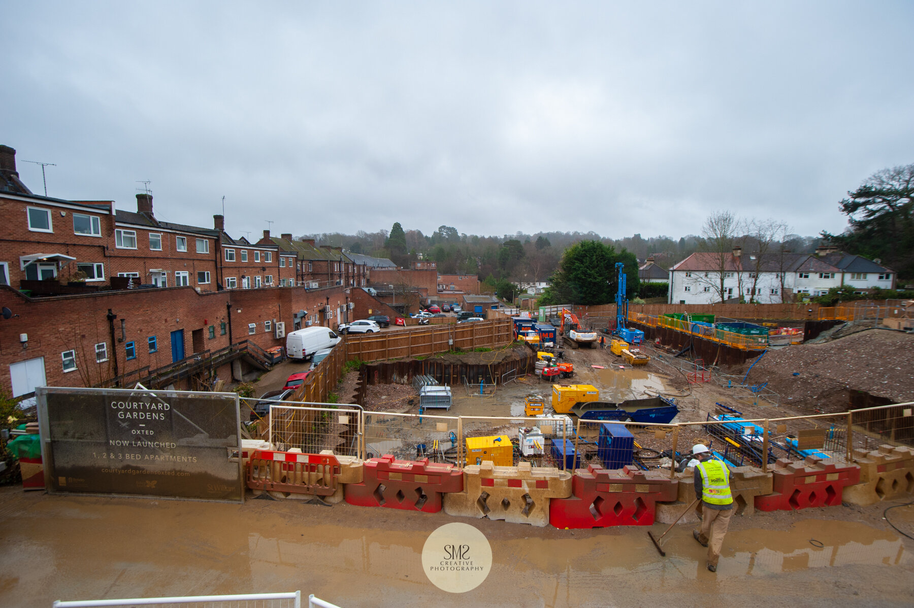  A view looking down towards Johnsdale. The underground car park foundations are in place. The road in the foreground will be one of the two entrances to Courtyards Gardens. Water is being swept away as deliveries arrive. 