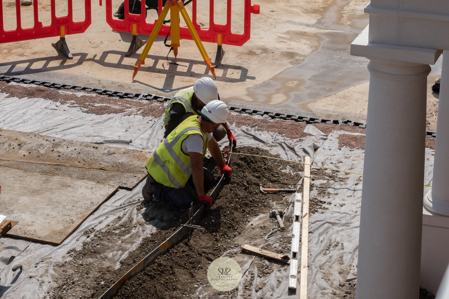  Preparing the steel edging of the pathways outside Block B 