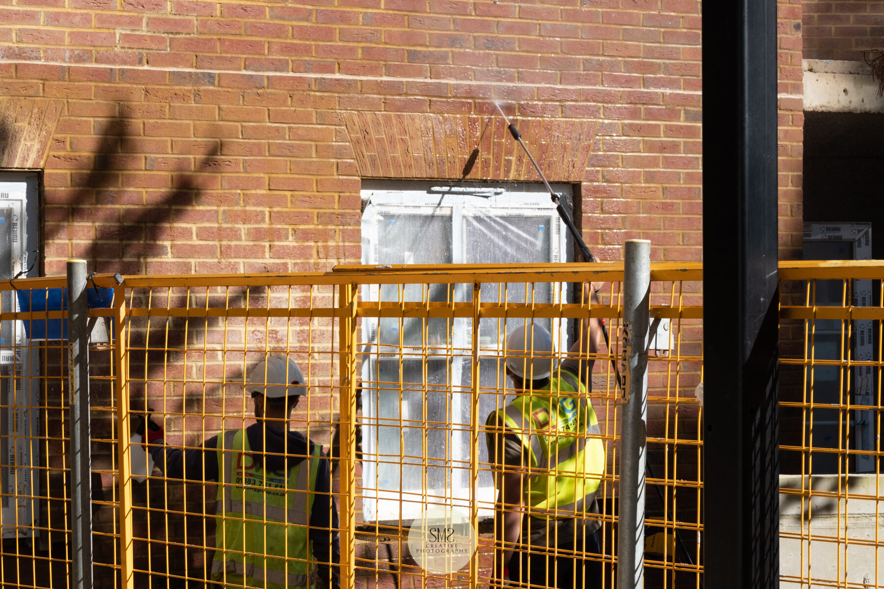  Spraying with water to clean the brickwork. 