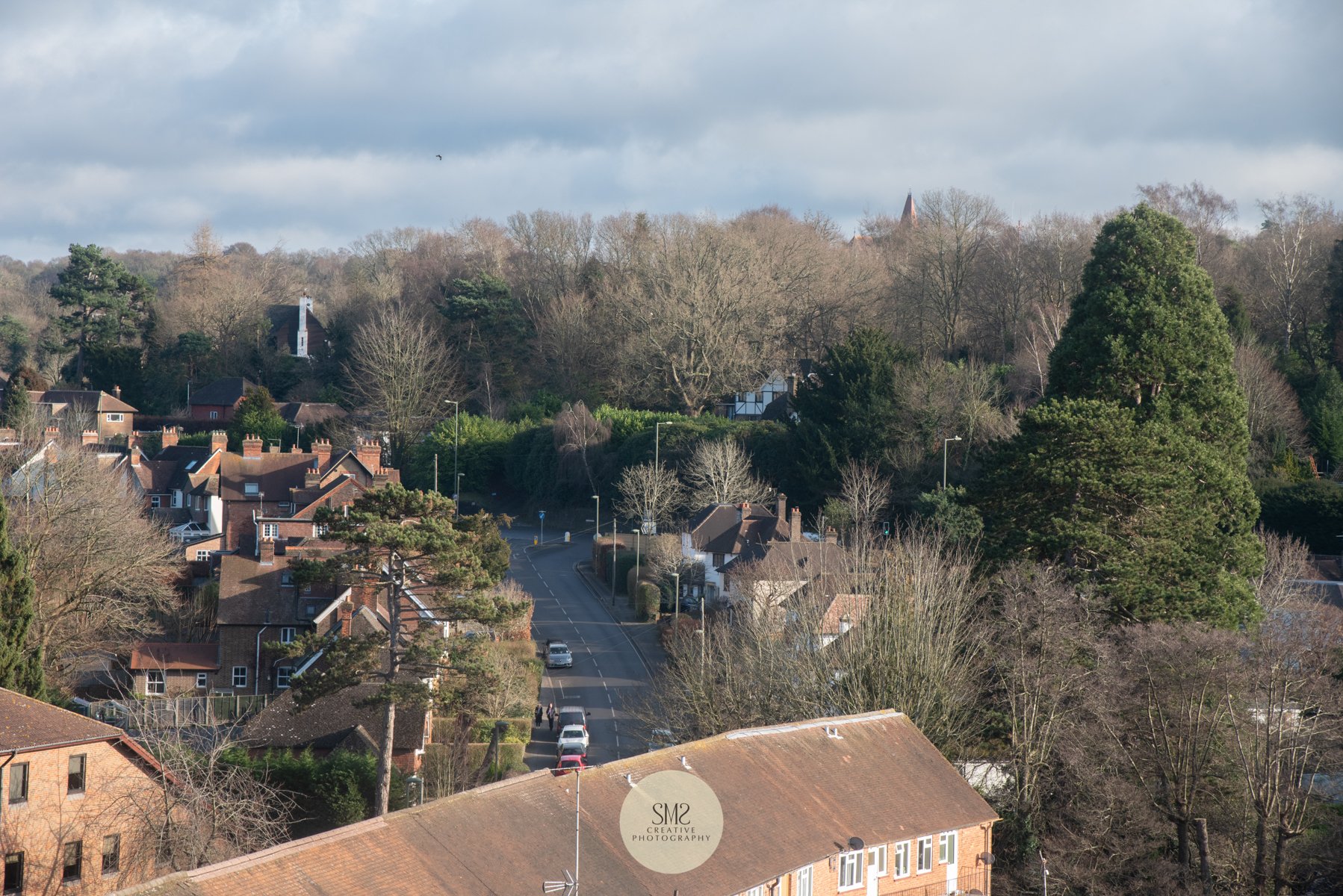  A view from a penthouse apartment terrace in Block C looking towards the top of Snatts Hill. The spire from St Michaels can be seen from above the trees centre-right. 
