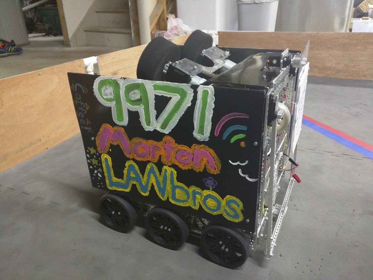 Morton was the first robot we created for the Velocity Vortex season. It featured a 6 wheel drive, powered by 2 NeveRest 40 motors on both sides of the robot. The motors were geared down 1.5:1 so that the robot would be fast and efficient on the field. This robot was built mainly to score particles into the center vortex. We used a conveyor belt to feed particles into the dual flywheels to launch the particles at a rapid speed to score them. In matches we usually averaged 8-10 particles scored in the vortex. Along with particle scoring, Morton featured multiple autonomous programs that allowed it to complete every objective in the autonomous period and be flexible with our alliance partners autonomous programs as well. For end-game, we had a forklift on the back of the robot that would allow the robot to lift the cap ball up to the low height; though we rarely did that and focused more on beacons during end-game. Morton was easily hitting the 190+ point range by itself by its last tournament which was the New Jersey P'Town Throwdown meet which was on December 10th, 2017. After that meet, we decided we wanted to score even higher so we created an Anomaly.