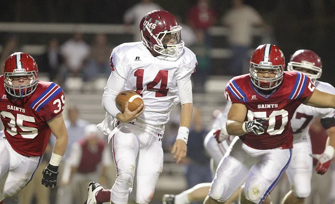 UMS-W quarterback running from St. Pauls tacklers in the "Battle of Old Shell Road"