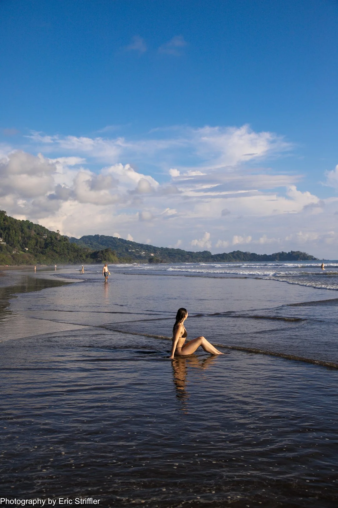 Rory sitting in the warm surf at Playa Dominical