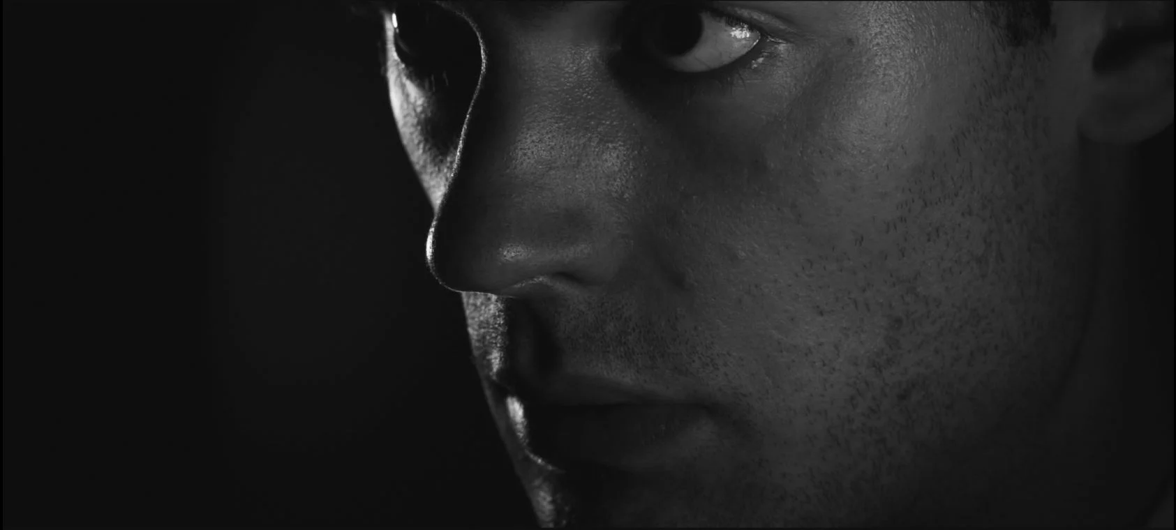 A close up on Woodrow from Brandon Pham Burnett's 2017 film "Bodies".