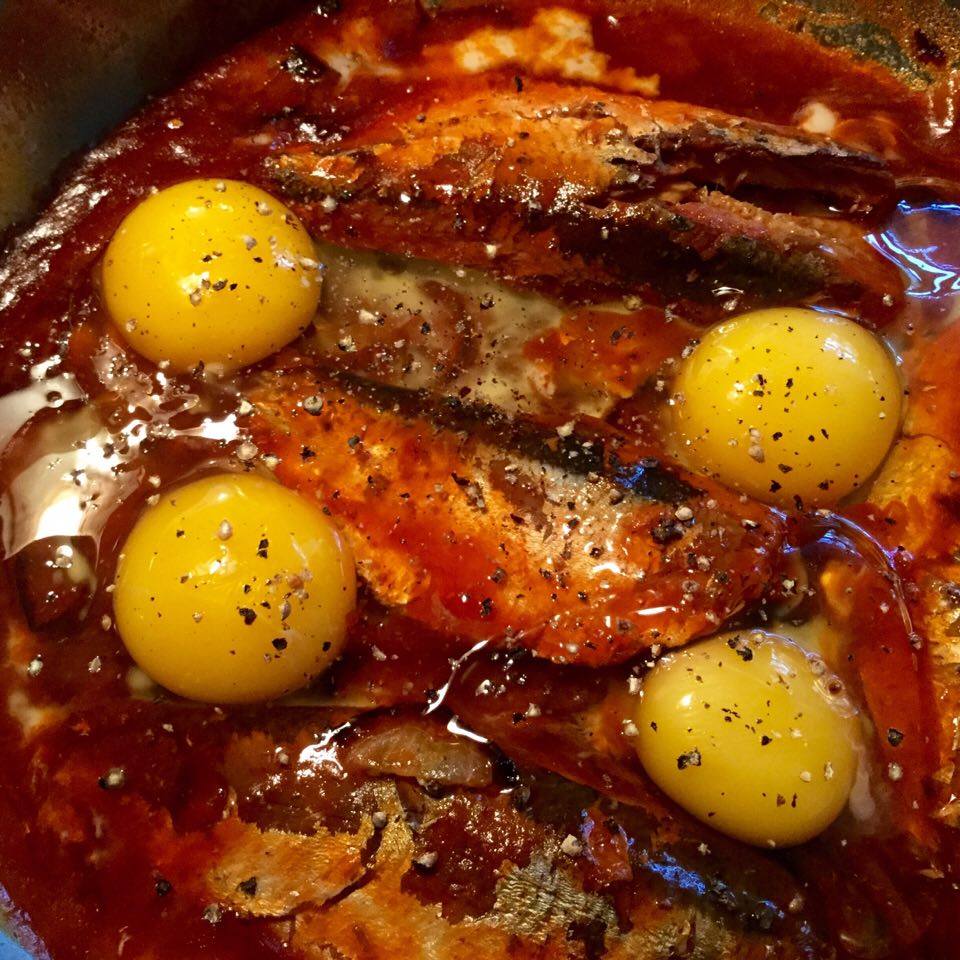 Once the sauce is reduced, top with eggs and place under the broiler on high for a minute or two until the eggs are set.