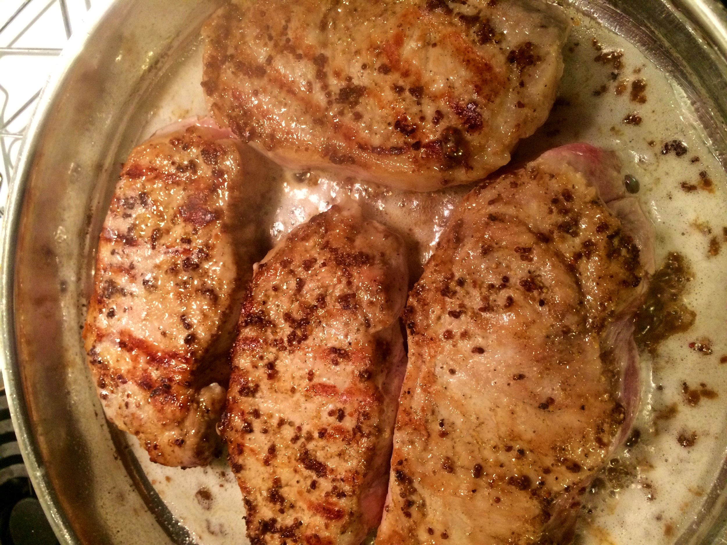After you have seared them for about a minute, turn them over and coat with the rest of the marinade.