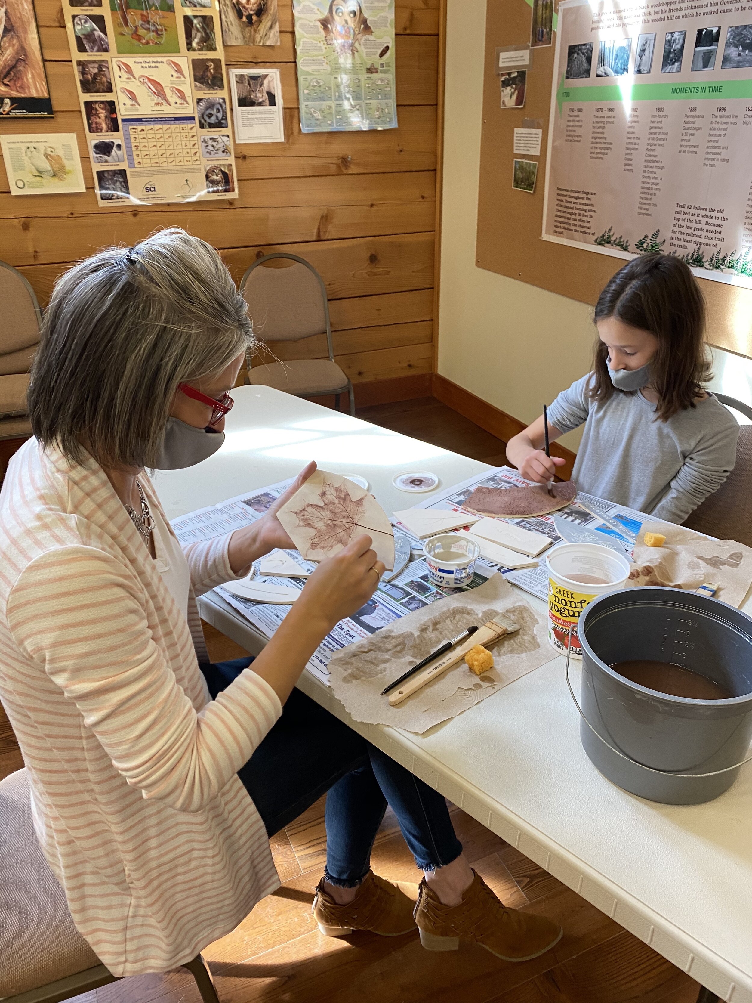  A week later, Nadine and Emma glazing the sugar maple and Red bud tree tiles. 
