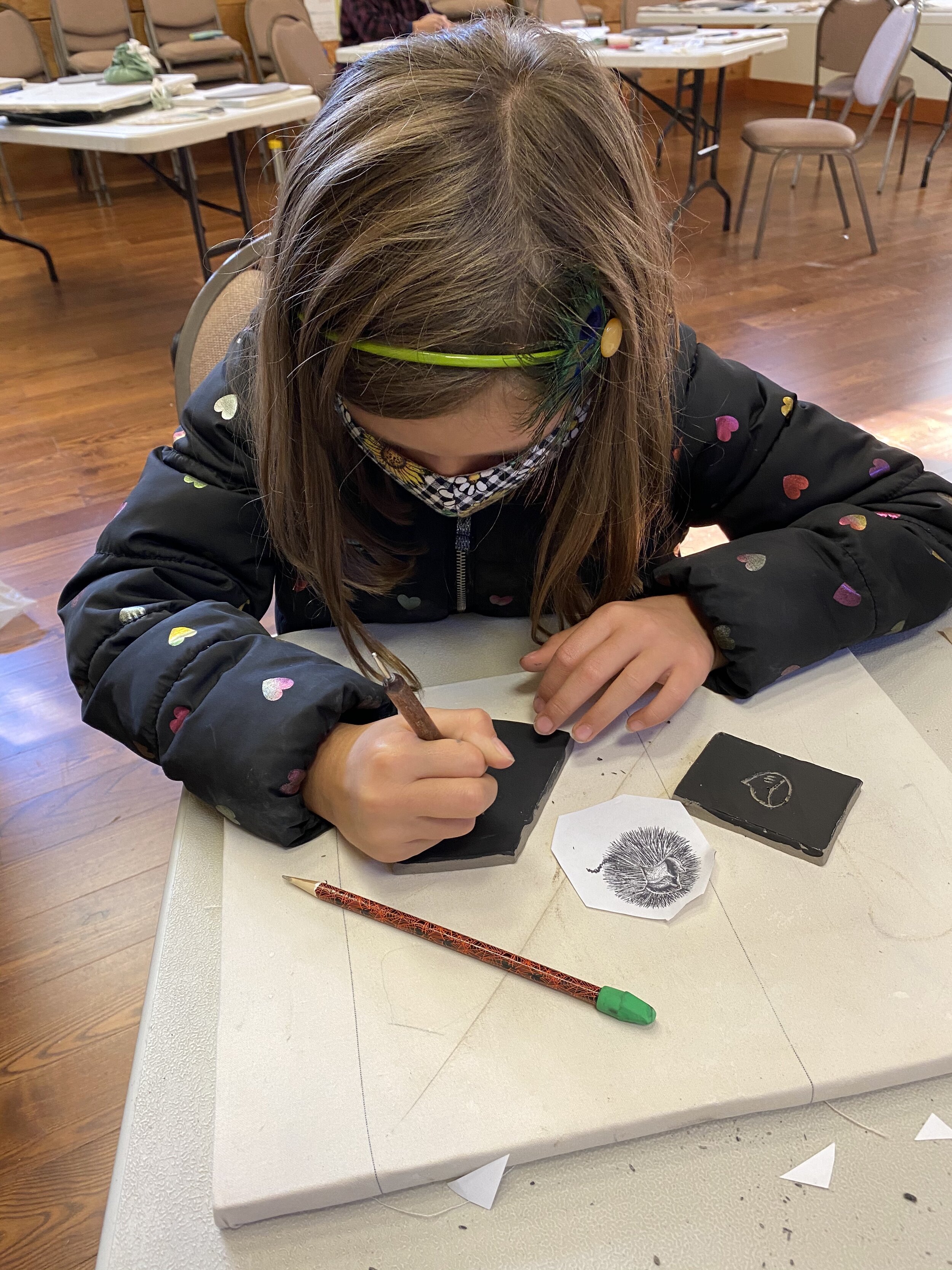  Elliana working on a sgraffito drawing of the nut of the American chestnut tree. 