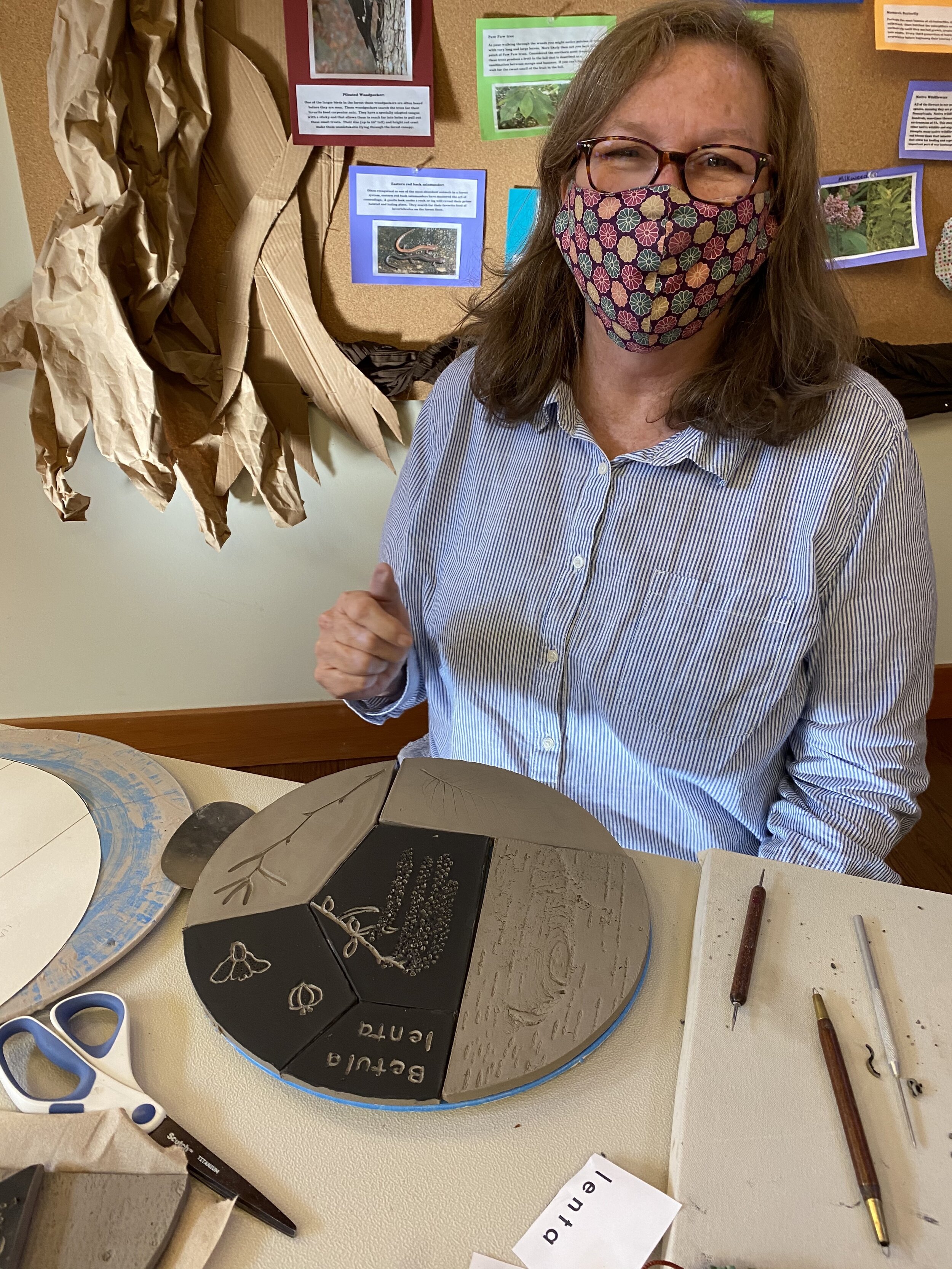  Sandra is finished with her tiles. She is smiling under her mask! 