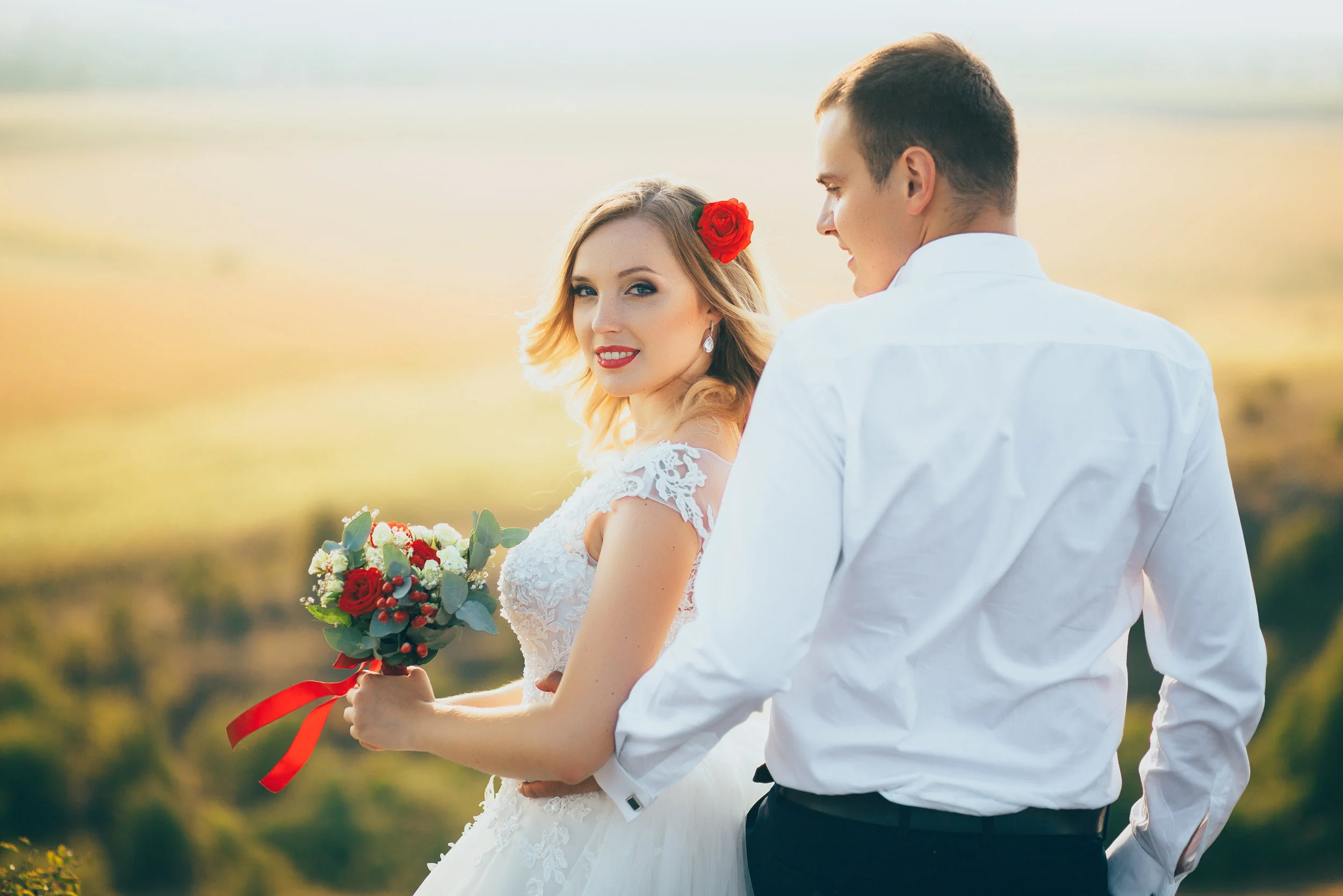 stylish gorgeous couple newlyweds standing on the rocks in the mountains