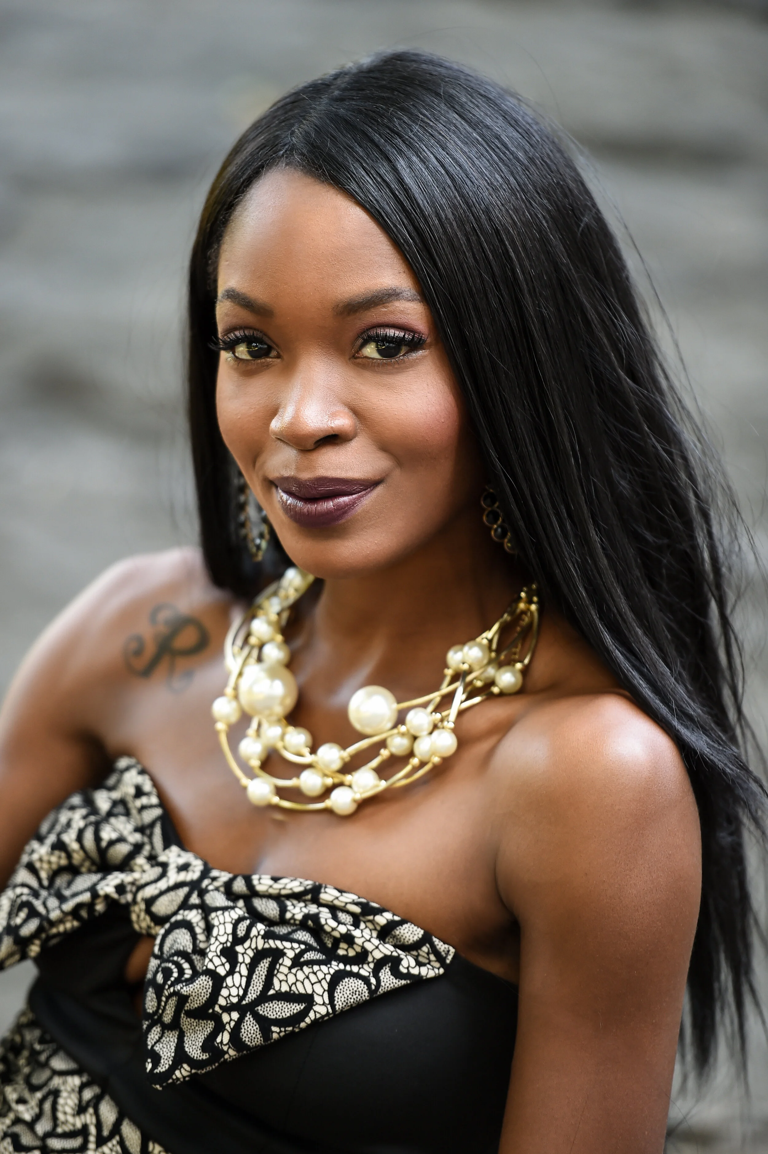 Outdoor portrait of beautiful young African American woman wearing sexy dress and jewelry.