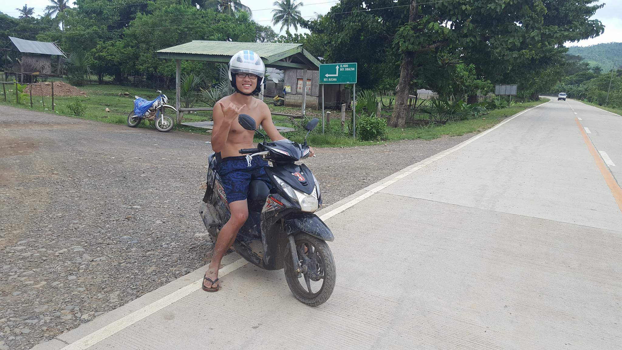 My best friend Yuting covered in mud, but still smiling. Prepare to get just as dirty! (In the back there is the sign for Bgy. Bucana)