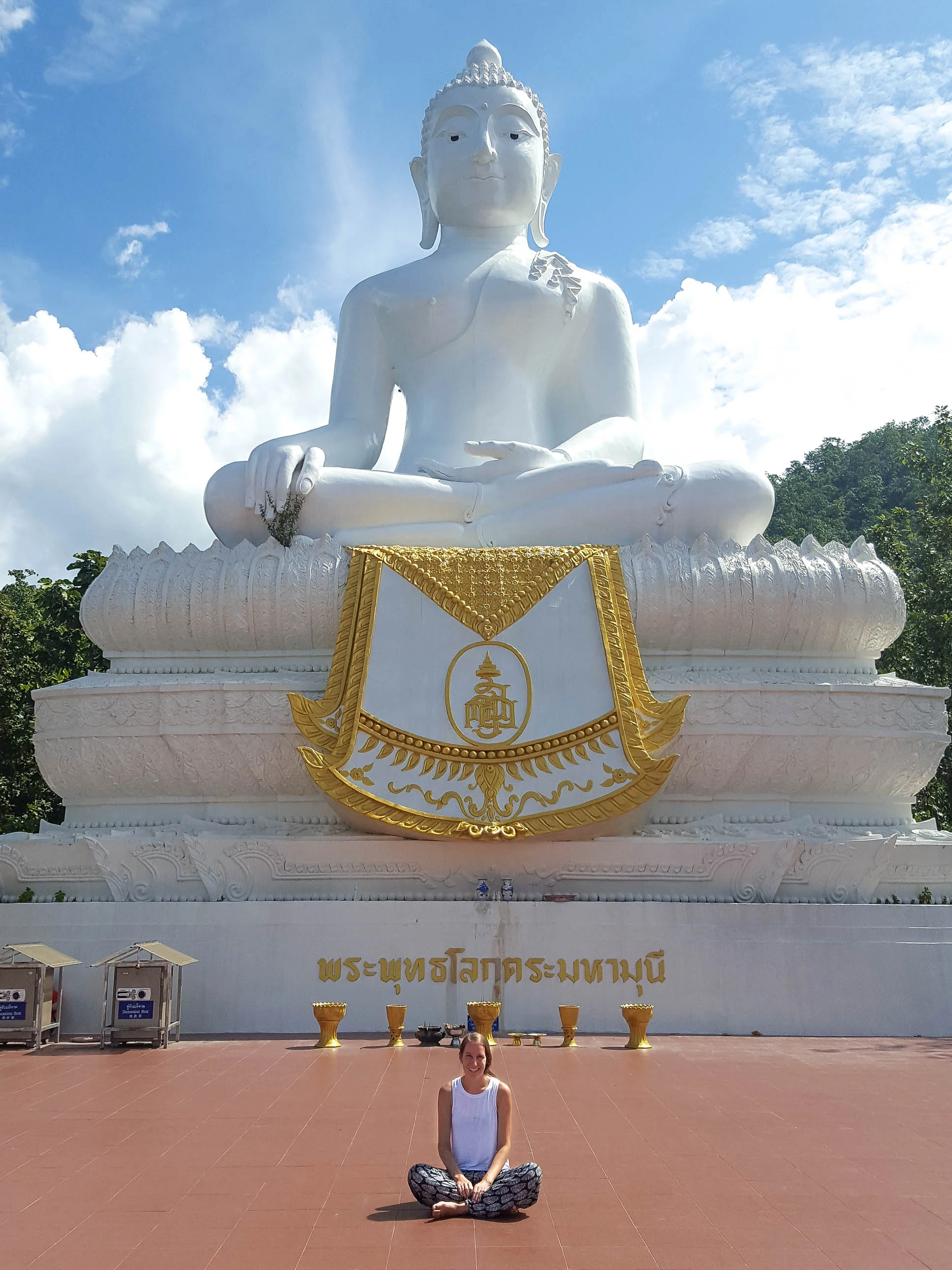 Sitting in front of the White Buddha statue in Pai, Thailand