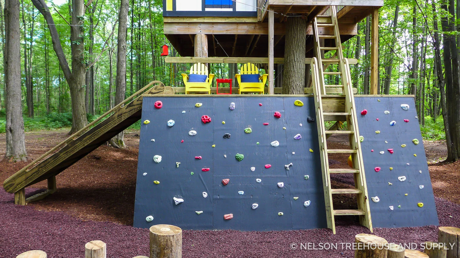 The crew enlarged the first platform to add more space for play, and added the rock wall and slide for extra adventurous entrances & exits. The ladder is a classic Nelson Treehouse ship ladder. You can find plans to make your own at store.beinatree.com!