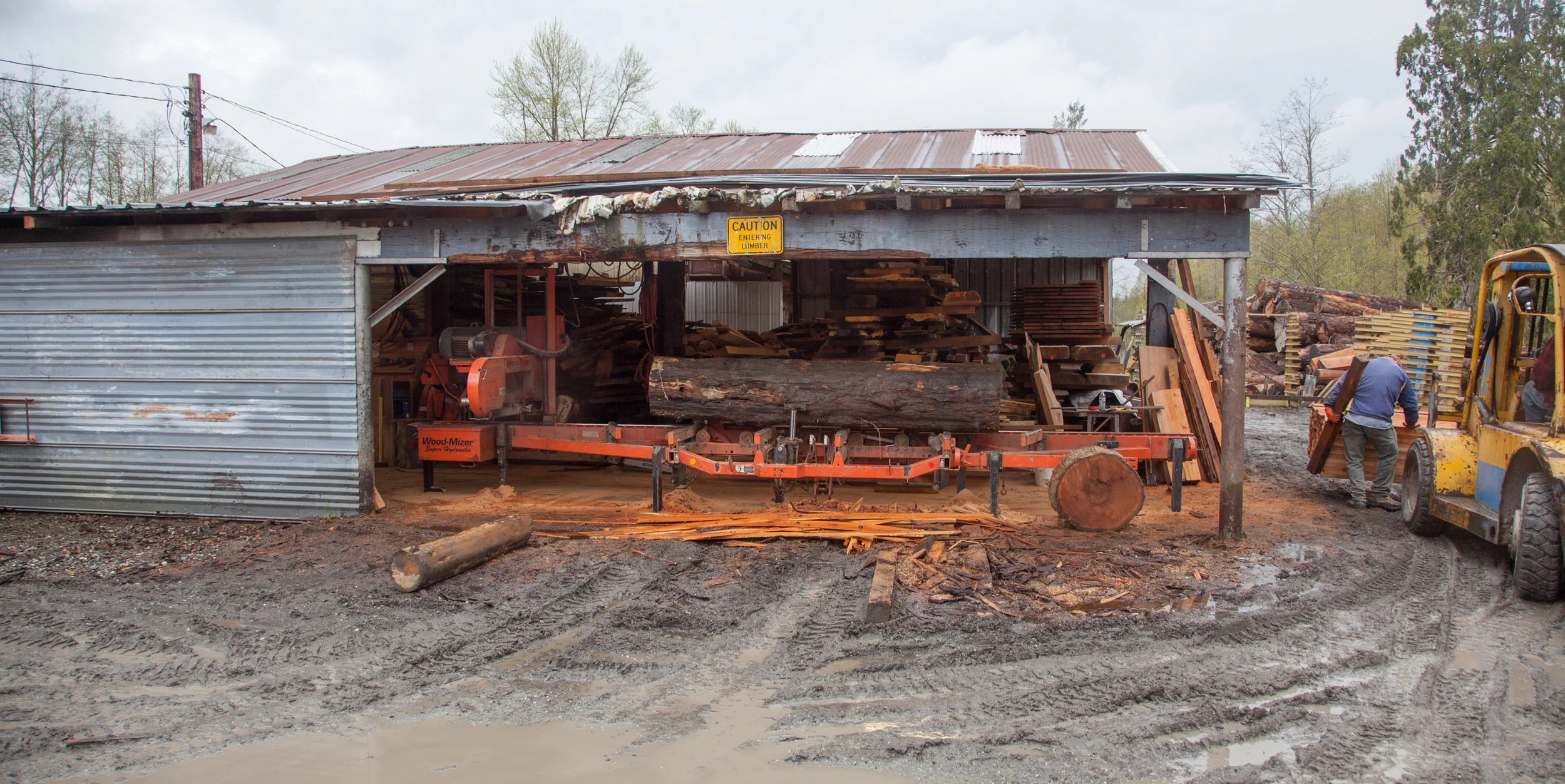 After bruce obtains reclaimed logs, he cuts slabs from them on his saw.