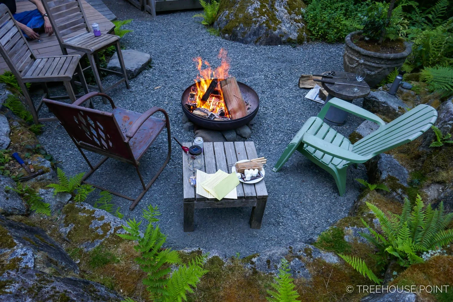 on clear nights, guests gather for s'mores and stargazing at the fire pit next to the lodge.