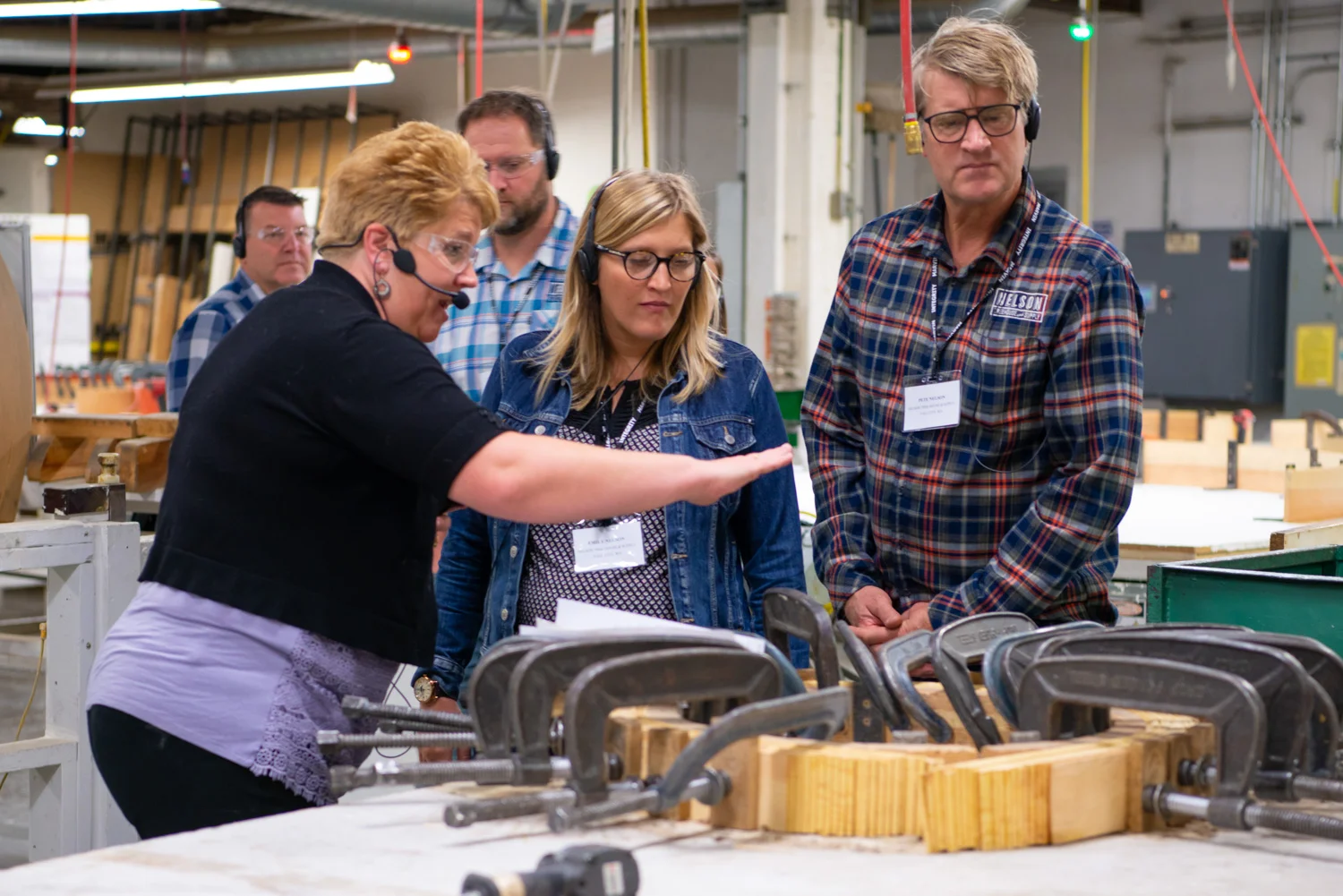 Nelson Treehouse Project Manager Daryl McDonald, Emily Nelson, and Pete Nelson learning about the Marvin Windows production process. PHoto courtesy of Marvin Windows.